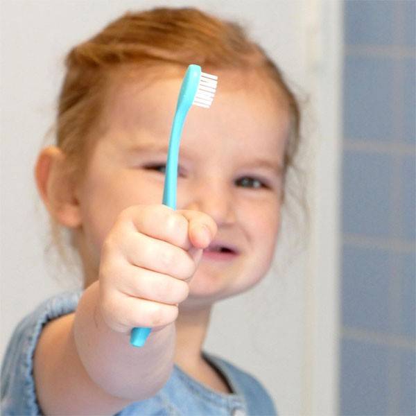 Blue children's toothbrush with refillable head - Caliquo - background view